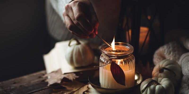 woman hand lighting candle